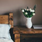 Bedside table styled with greenery